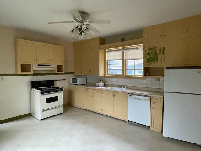 kitchen with a ceiling fan, white appliances, light countertops, under cabinet range hood, and a sink