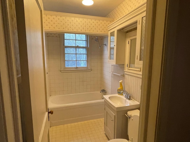 bathroom with vanity, shower / bathing tub combination, and wallpapered walls