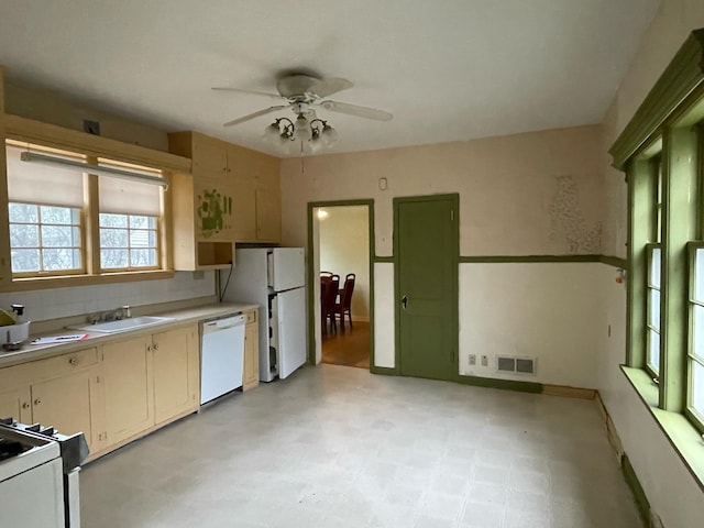 kitchen with visible vents, a ceiling fan, white appliances, light countertops, and a sink