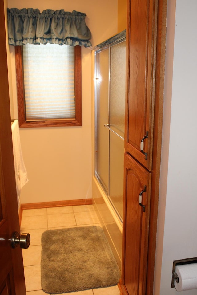 5795 Otter Lake Rd, White Bear Twp, MN 55110 - bathroom with tile patterned flooring and bath / shower combo with glass door