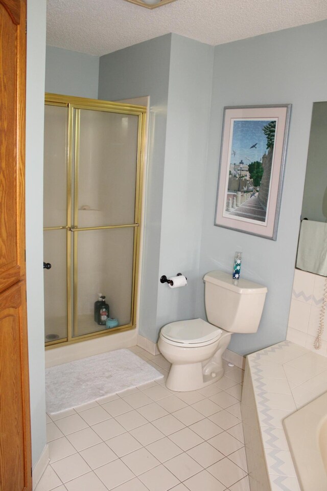 5795 Otter Lake Rd, White Bear Twp, MN 55110 - full bath with a stall shower, a textured ceiling, and tile patterned flooring