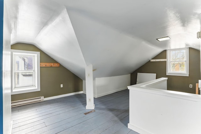 bonus room featuring hardwood / wood-style flooring, a baseboard heating unit, baseboards, and lofted ceiling