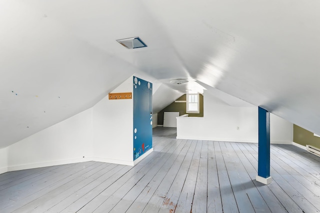 bonus room featuring baseboards, wood finished floors, and lofted ceiling