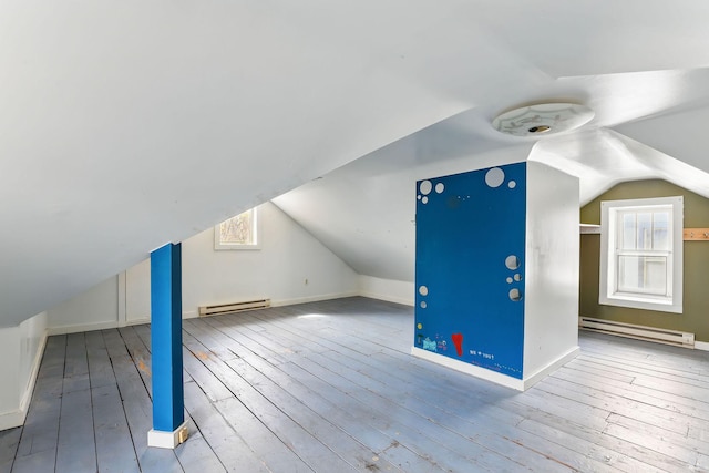 bonus room with baseboard heating, hardwood / wood-style floors, and lofted ceiling
