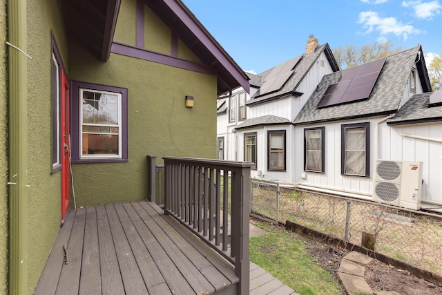 wooden terrace with fence and ac unit