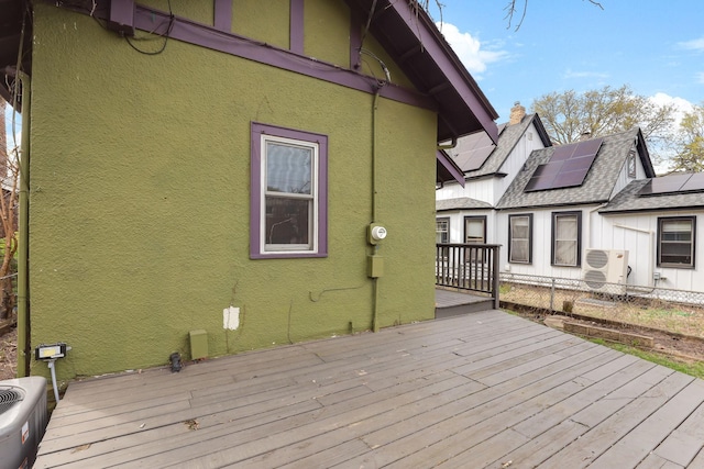 wooden terrace featuring cooling unit and ac unit