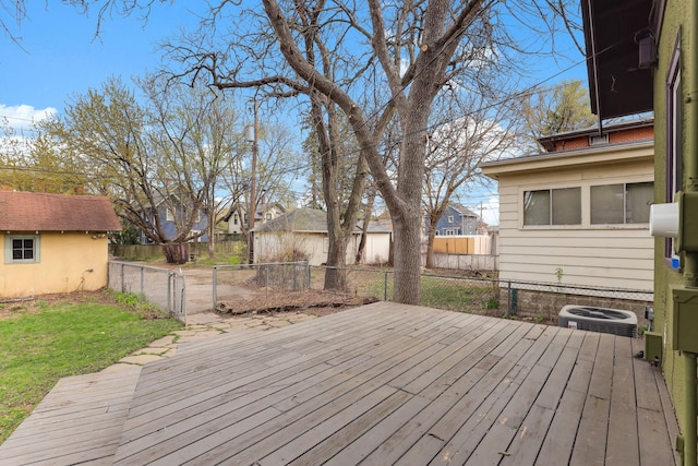 wooden terrace with a lawn, a fenced backyard, central AC, and a residential view