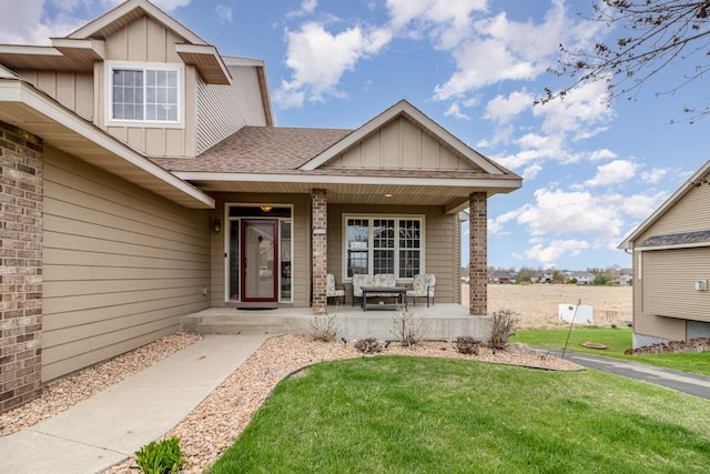 1006 9th Street Ct SE, New Prague, MN 56071 - property entrance featuring board and batten siding, a porch, a lawn, and roof with shingles