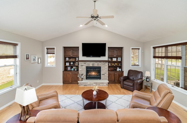 1006 9th Street Ct SE, New Prague, MN 56071 - living area featuring light wood finished floors, lofted ceiling, a brick fireplace, and baseboards