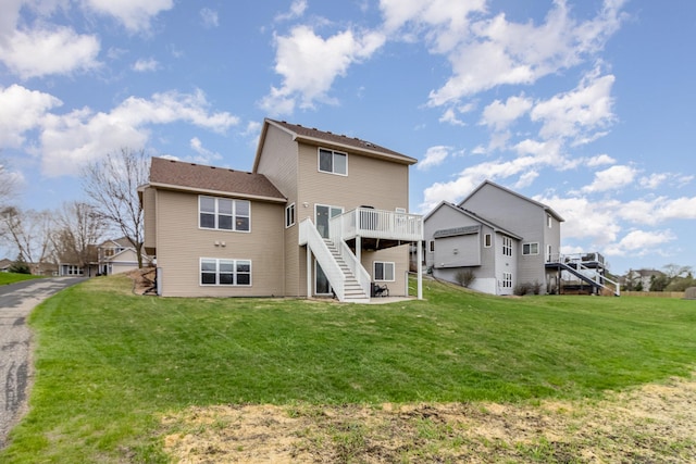 1006 9th Street Ct SE, New Prague, MN 56071 - back of house featuring stairs, a wooden deck, and a lawn