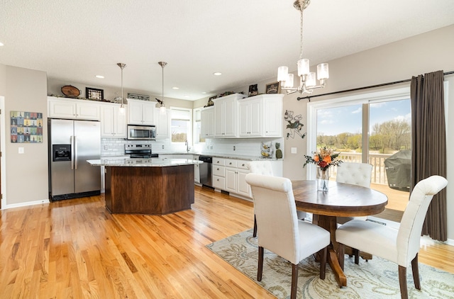 1006 9th Street Ct SE, New Prague, MN 56071 - dining room featuring a chandelier, plenty of natural light, light wood-style flooring, and recessed lighting