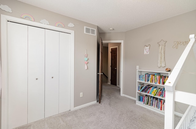 1006 9th Street Ct SE, New Prague, MN 56071 - carpeted bedroom featuring baseboards, a closet, and a textured ceiling