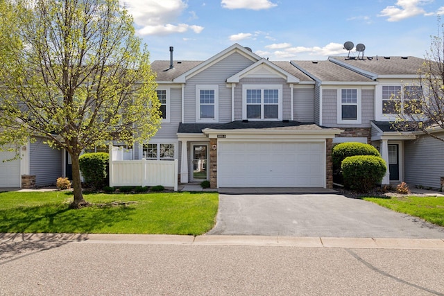5085 149th St N # 3, Hugo, MN 55038 - multi unit property featuring asphalt driveway, stone siding, an attached garage, and a front lawn