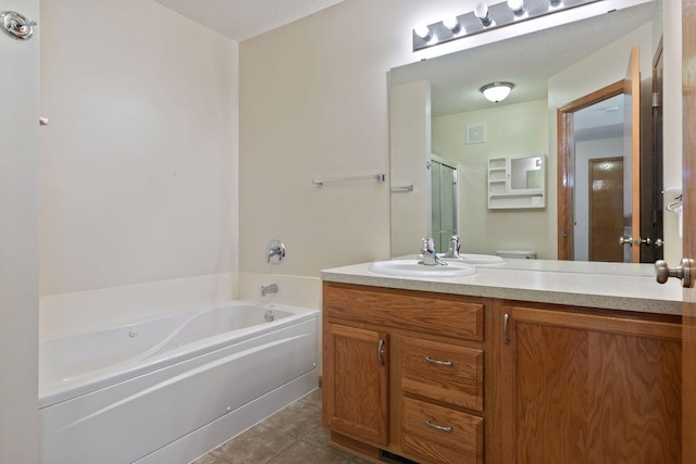 5085 149th St N # 3, Hugo, MN 55038 - bathroom featuring vanity, a garden tub, tile patterned floors, a shower stall, and toilet