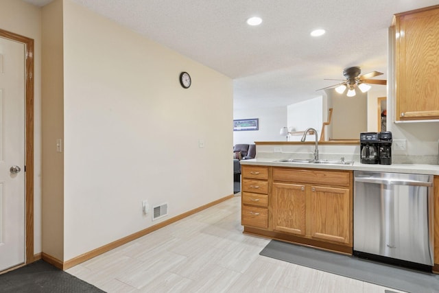 5085 149th St N # 3, Hugo, MN 55038 - kitchen featuring stainless steel dishwasher, a sink, a ceiling fan, a peninsula, and light countertops