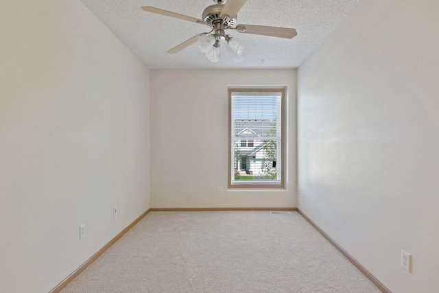 5085 149th St N # 3, Hugo, MN 55038 - spare room with a textured ceiling, light colored carpet, baseboards, and a ceiling fan