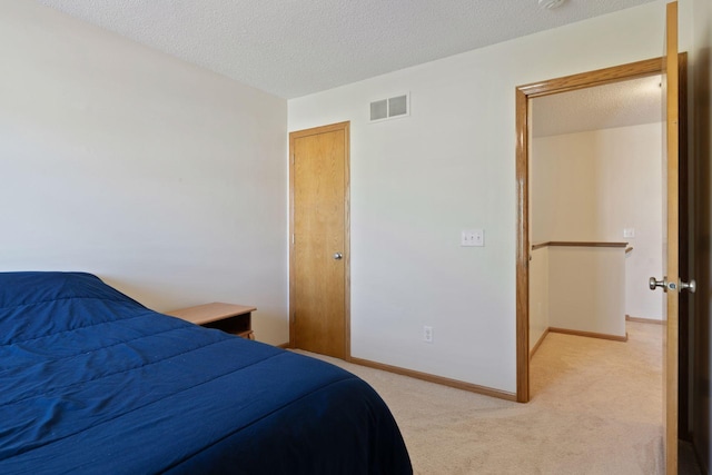 5085 149th St N # 3, Hugo, MN 55038 - bedroom featuring light carpet, a textured ceiling, and baseboards