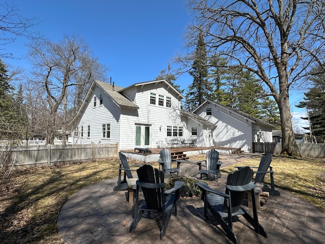 back of house with fence, a patio, a fire pit, and french doors