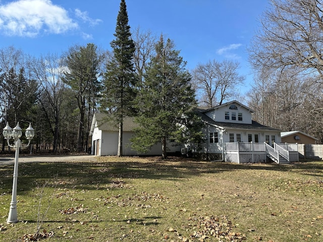 exterior space with french doors, a wooden deck, and a lawn