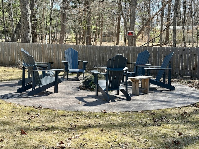 view of patio featuring fence and a fire pit