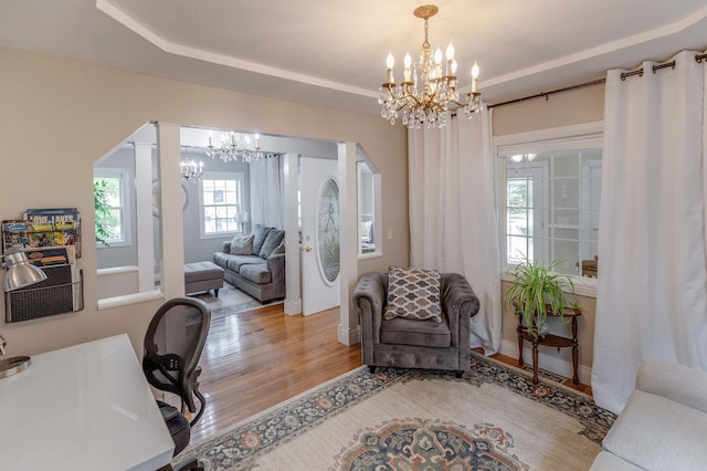 office area featuring an inviting chandelier and wood finished floors