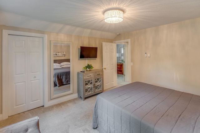 bedroom featuring a notable chandelier and light carpet