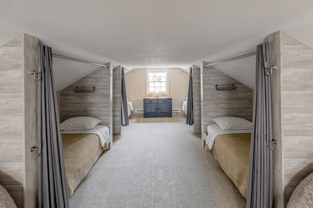 bedroom with light colored carpet, a baseboard radiator, wooden walls, and vaulted ceiling