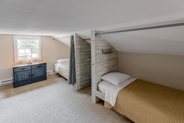 bedroom with light carpet, vaulted ceiling, and a baseboard heating unit
