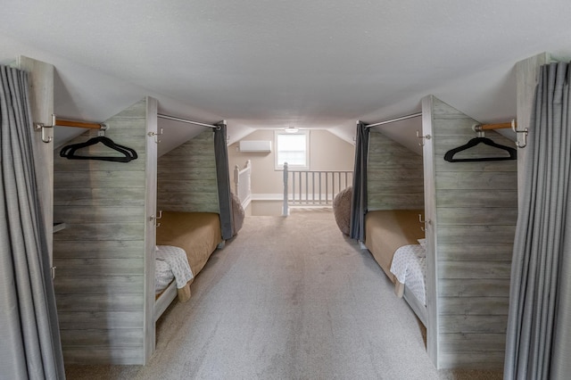 interior space featuring vaulted ceiling and carpet flooring