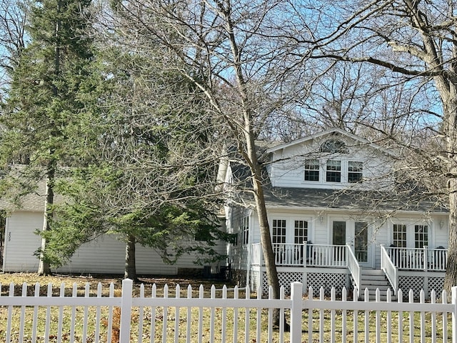 view of front facade with a fenced front yard and a wooden deck