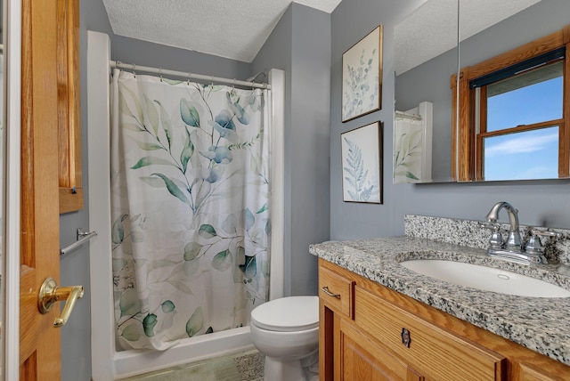 bathroom featuring toilet, a textured ceiling, a shower with shower curtain, and vanity