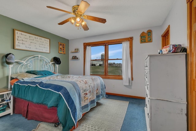 carpeted bedroom featuring baseboards and a ceiling fan