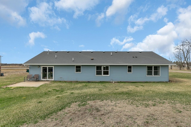 back of house featuring a patio area and a yard