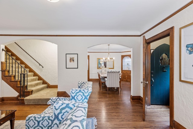 1722 Pinehurst Ave, Saint Paul, MN 55116 - living room featuring wood finished floors, baseboards, arched walkways, crown molding, and stairway