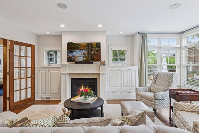 1722 Pinehurst Ave, Saint Paul, MN 55116 - living room featuring wood finished floors, healthy amount of natural light, a tiled fireplace, and recessed lighting