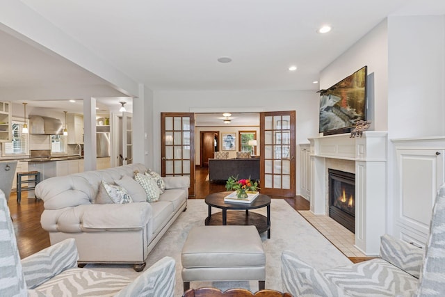 1722 Pinehurst Ave, Saint Paul, MN 55116 - living area featuring french doors, a fireplace with flush hearth, light wood-style floors, and recessed lighting