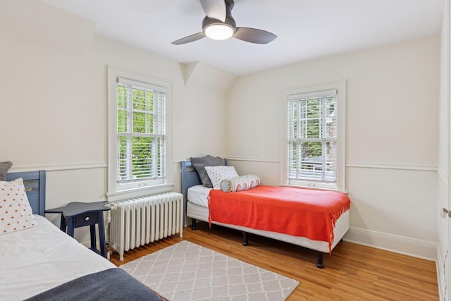 1722 Pinehurst Ave, Saint Paul, MN 55116 - bedroom with radiator, wood finished floors, a ceiling fan, and baseboards