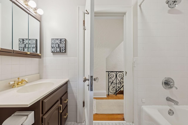 1722 Pinehurst Ave, Saint Paul, MN 55116 - bathroom featuring shower / bath combination, vanity, and tile walls