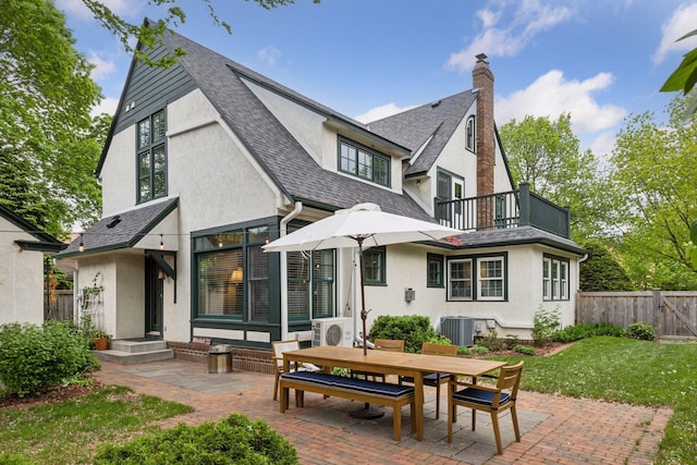 1722 Pinehurst Ave, Saint Paul, MN 55116 - back of property with stucco siding, a balcony, a patio area, and a shingled roof