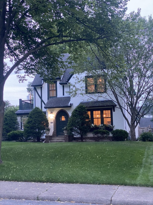 1722 Pinehurst Ave, Saint Paul, MN 55116 - view of front of home featuring stucco siding, a front lawn, and a balcony