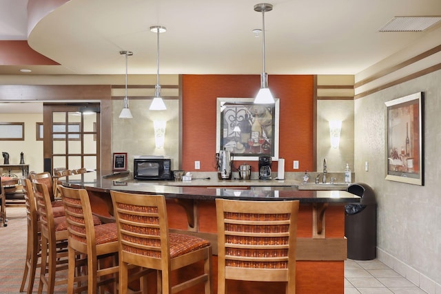 7100 Metro Blvd Unit 401, Edina, MN 55439 - bar with visible vents, black microwave, pendant lighting, light tile patterned floors, and indoor wet bar