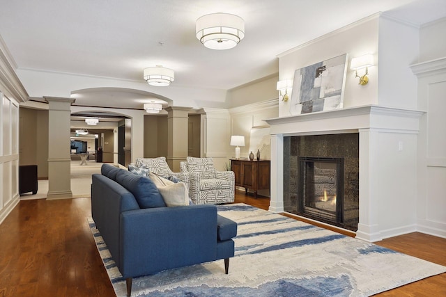 7100 Metro Blvd Unit 401, Edina, MN 55439 - living area with arched walkways, decorative columns, wood finished floors, and a tile fireplace