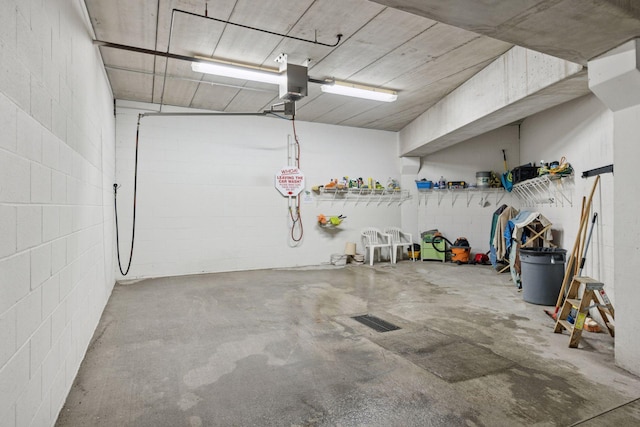 7100 Metro Blvd Unit 401, Edina, MN 55439 - garage featuring visible vents, a garage door opener, and concrete block wall