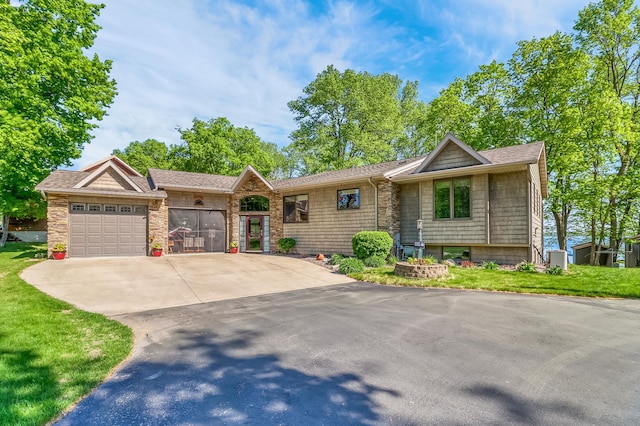 21005 County Highway 32, Rochert, MN 56578 - view of front of property with an attached garage, driveway, a shingled roof, and a front lawn