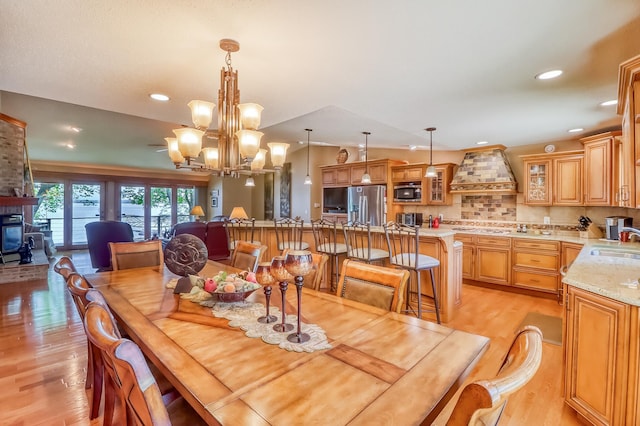21005 County Highway 32, Rochert, MN 56578 - dining room featuring light wood-style flooring, a chandelier, recessed lighting, and vaulted ceiling