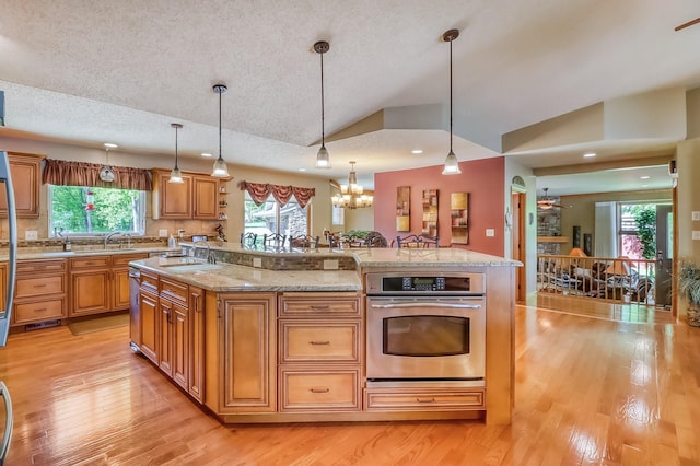 21005 County Highway 32, Rochert, MN 56578 - kitchen featuring stainless steel oven, a sink, vaulted ceiling, a textured ceiling, and light wood-style floors