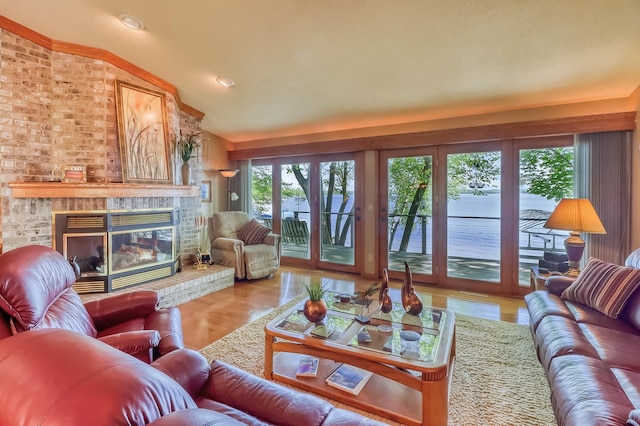 21005 County Highway 32, Rochert, MN 56578 - living area with vaulted ceiling, a brick fireplace, wood finished floors, and recessed lighting