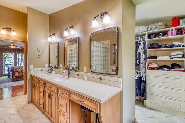 21005 County Highway 32, Rochert, MN 56578 - full bath featuring tile patterned flooring, double vanity, a ceiling fan, ensuite bathroom, and backsplash