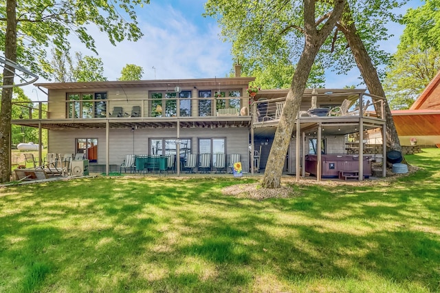 21005 County Highway 32, Rochert, MN 56578 - rear view of property featuring a hot tub, a lawn, a balcony, and a chimney