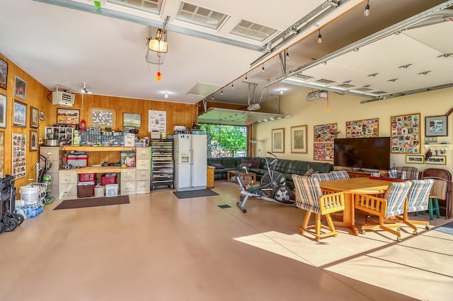 21005 County Highway 32, Rochert, MN 56578 - garage with white fridge with ice dispenser and wooden walls